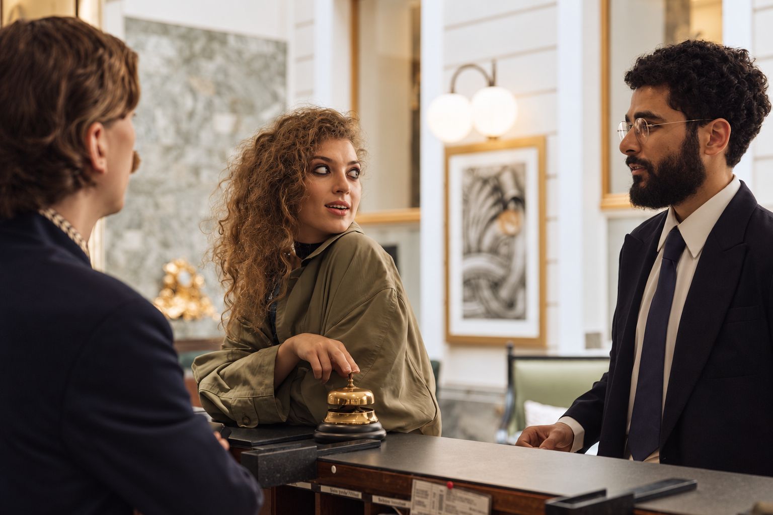 Guests in conversation with a concierge at an elegant hotel reception