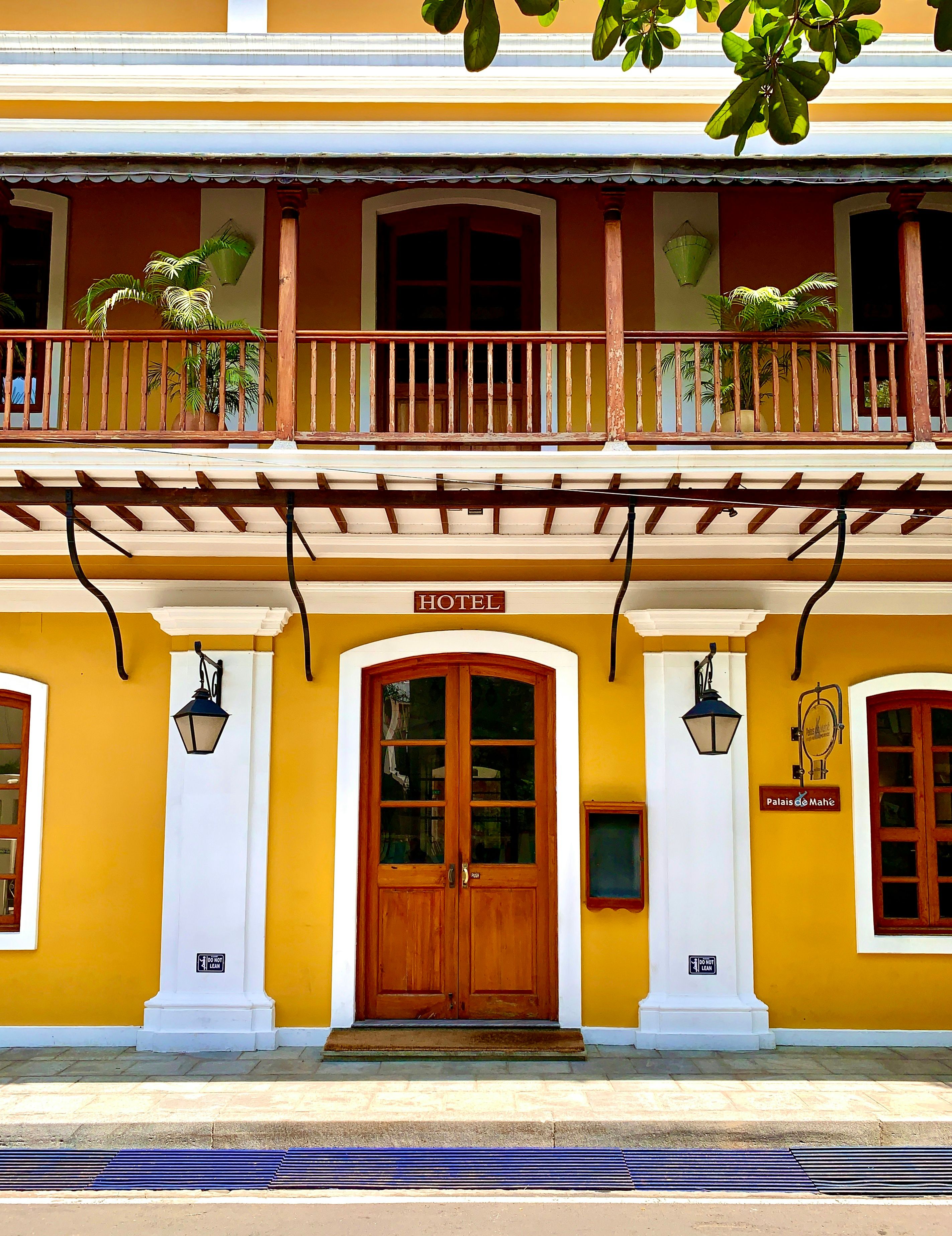 Yellow walls, white columns and a wooden balcony at Palais de Mahé in Pondicherry