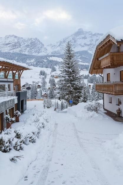 A snow-covered village lane between houses