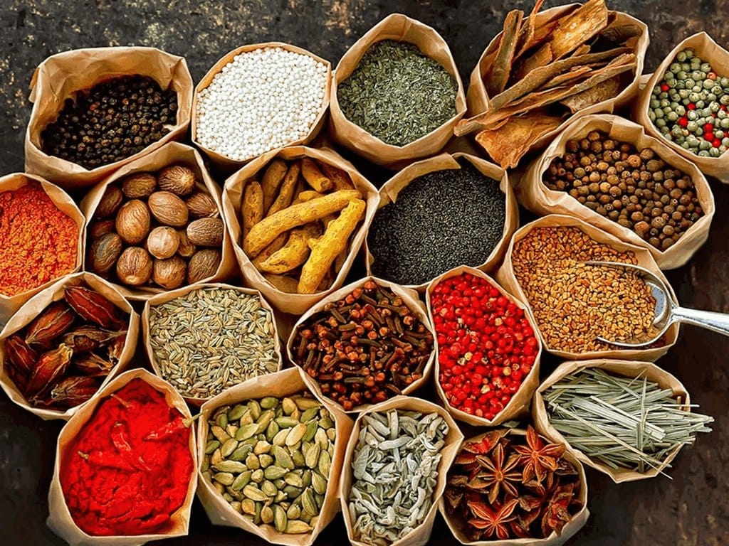 Bowls and baskets filled with colorful spices