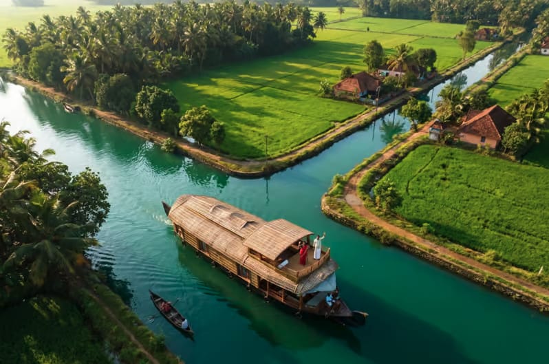 Aerial view of a houseboat passing green fields