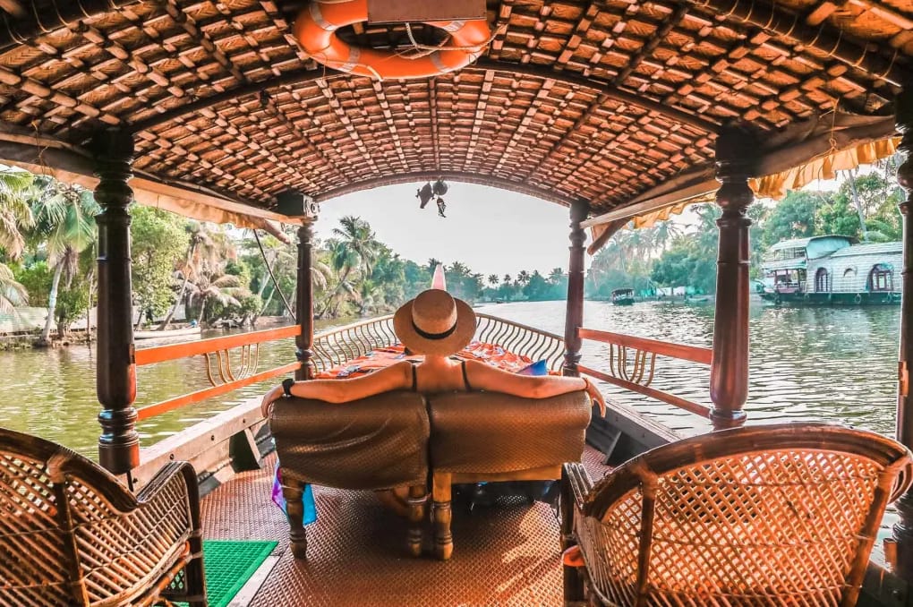 A seated guest looking out from a houseboat deck