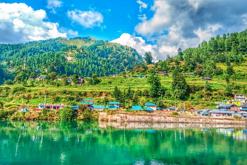 A small village reflected in a calm mountain lake