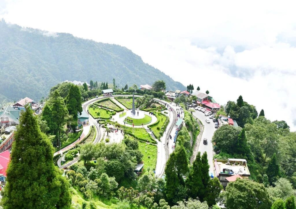 A landscaped hilltop garden with a looping railway track