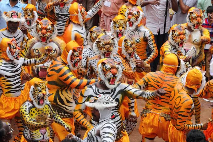 Festival performers with tiger-painted bodies
