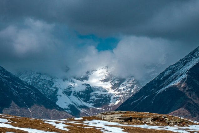 Low clouds above a snowy high mountain valley