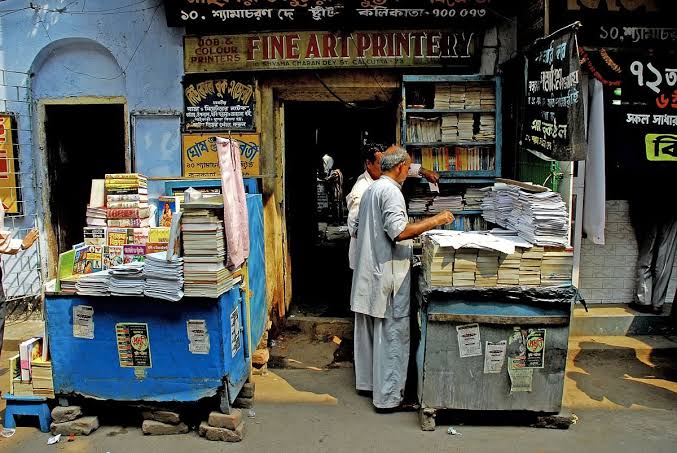A customer browsing a small book stall