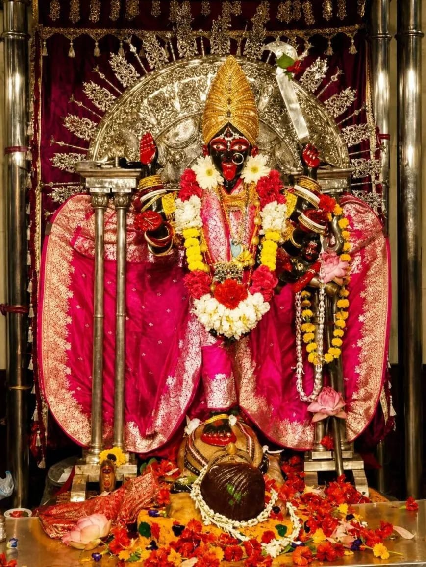 A decorated deity displayed within a temple shrine