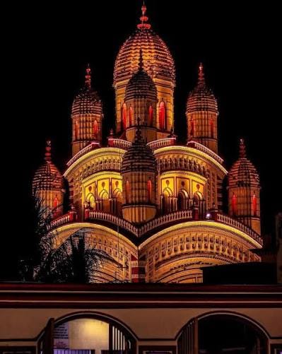 Temple domes illuminated against the night sky