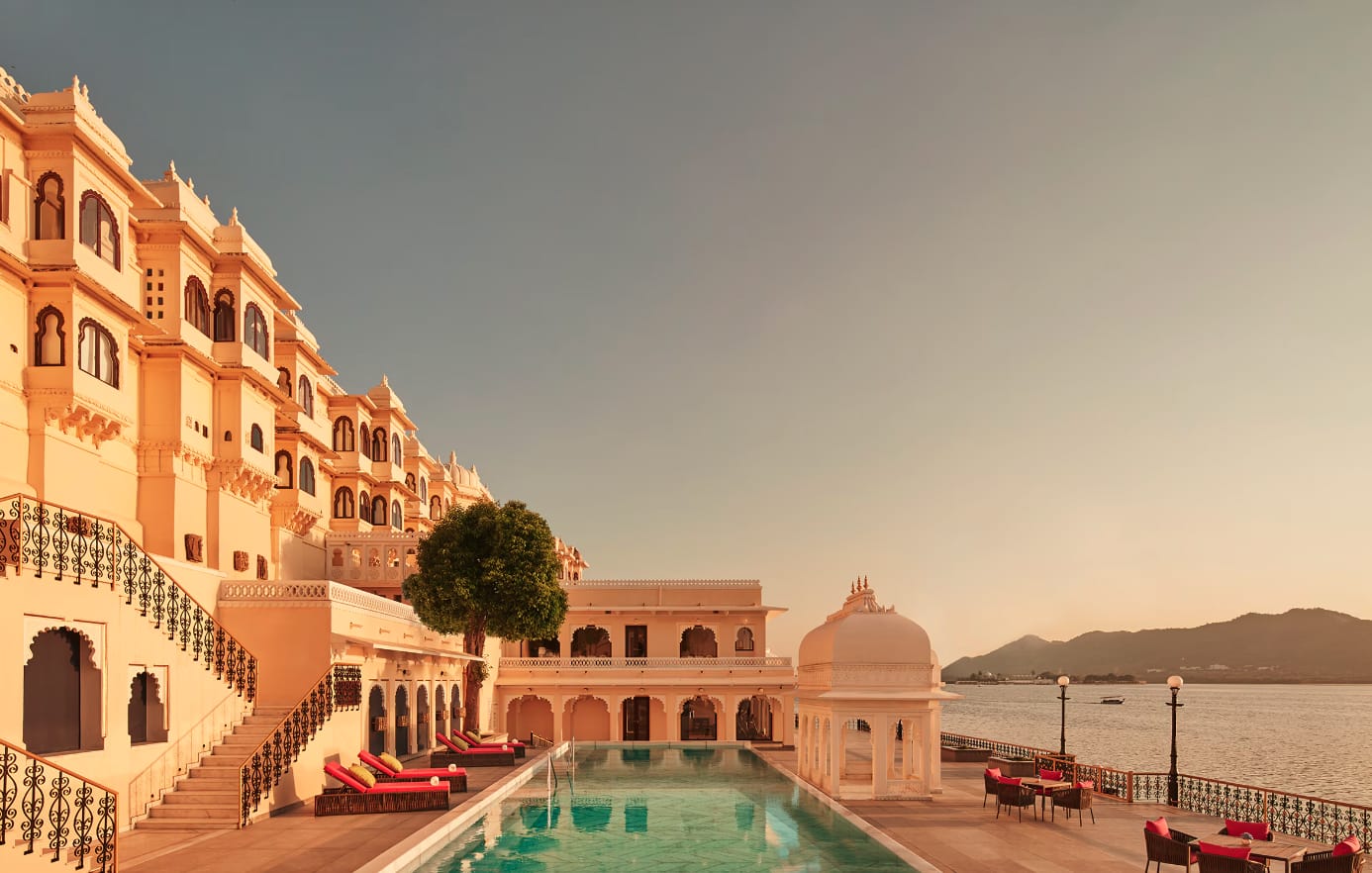 A palace terrace and swimming pool overlooking the lake