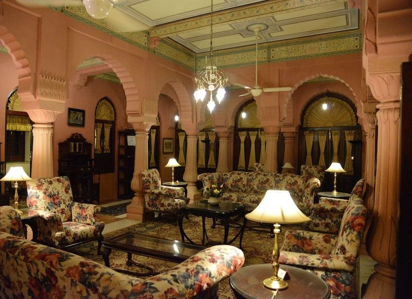 An arched sitting room with dark wooden furnishings