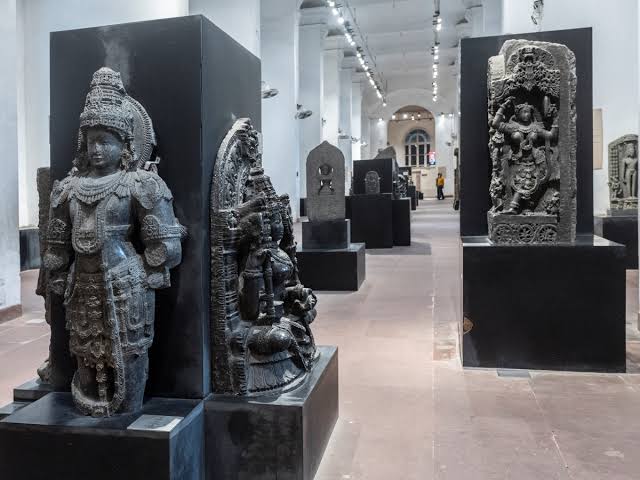 Stone sculptures displayed in a museum corridor