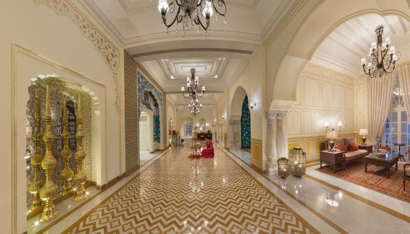 A chandelier-lit corridor with arched doorways