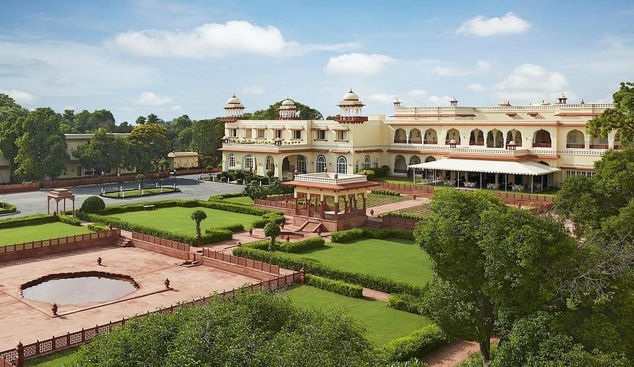 Formal lawns and fountains outside a palace hotel
