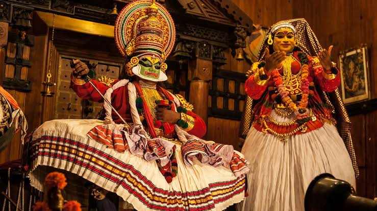 Costumed Kathakali performers taking part in a stage scene