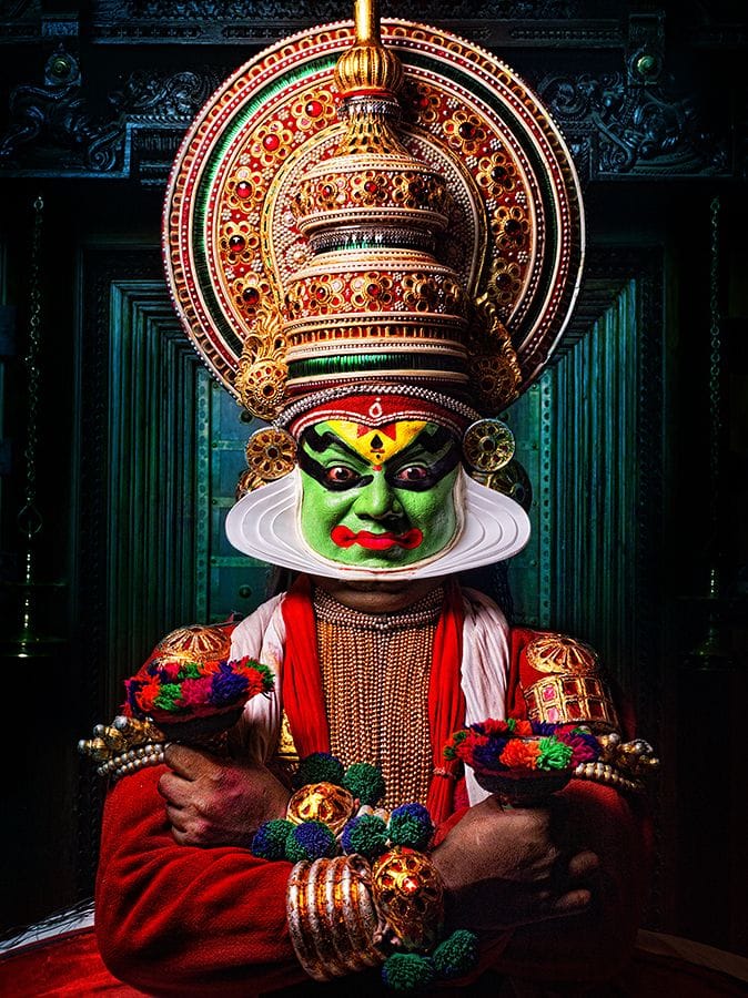 A Kathakali performer wearing an elaborate headdress and green face makeup