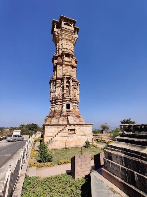 A carved stone tower rising above a historic courtyard