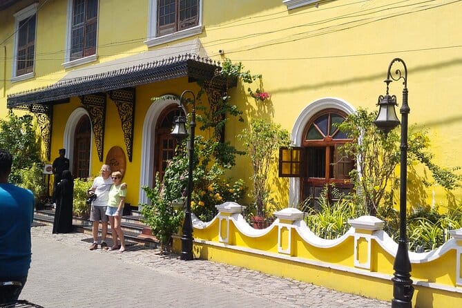A yellow colonial-style building on a quiet street