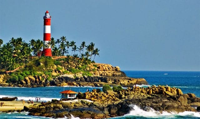 A red and white lighthouse above a rocky coast