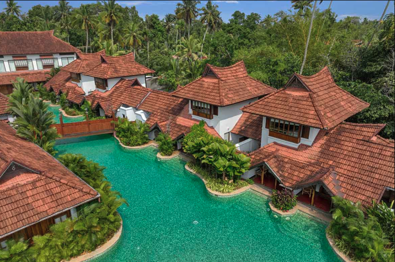 Tiled-roof cottages beside a landscaped swimming pool