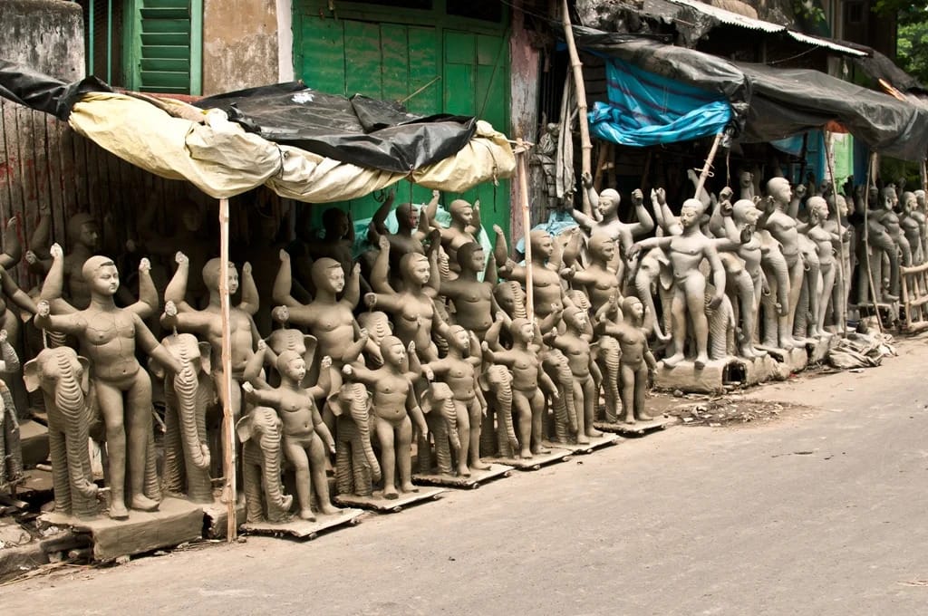 Rows of unfinished clay idols outside workshops