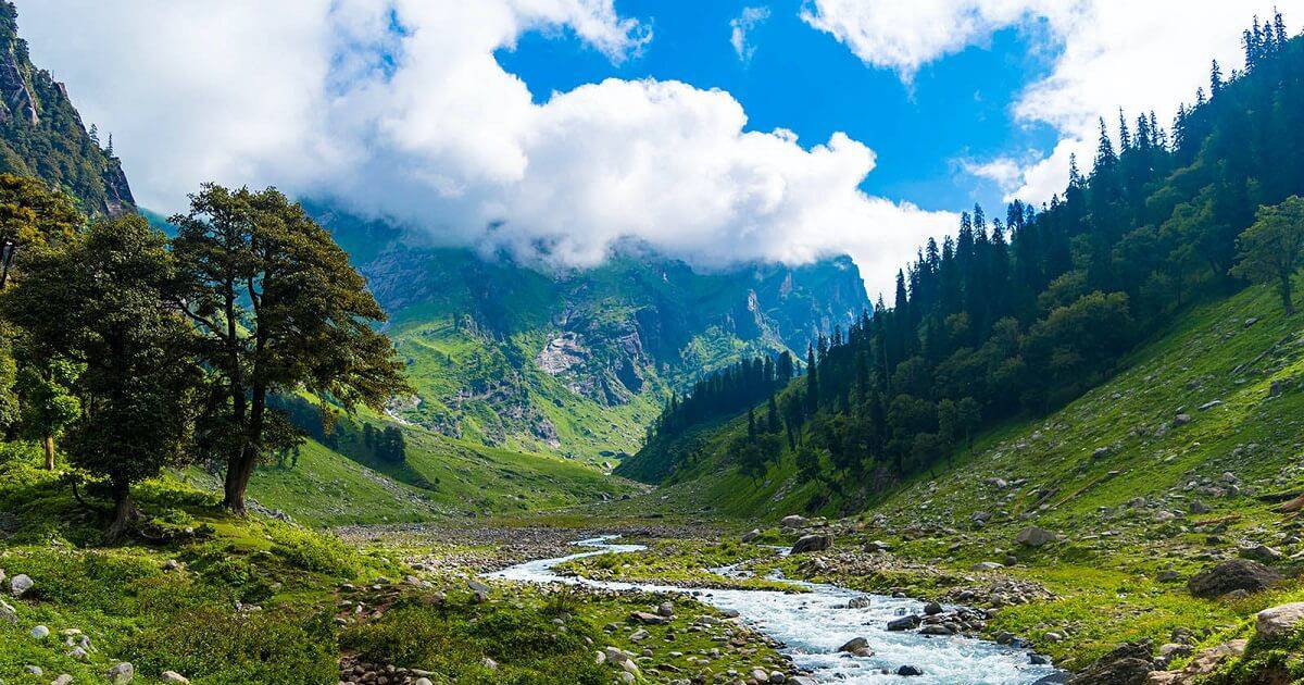 A green mountain valley with a rocky stream