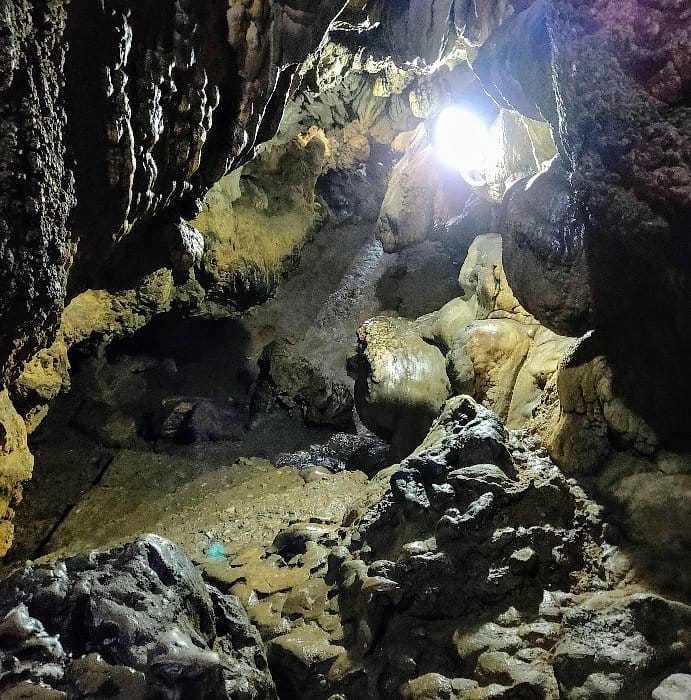 Sunlight entering a dark rocky cave