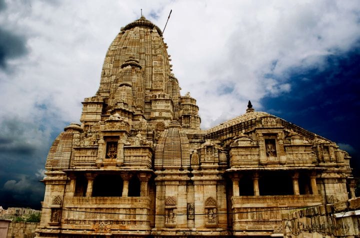 An ornate stone temple with a tall carved tower