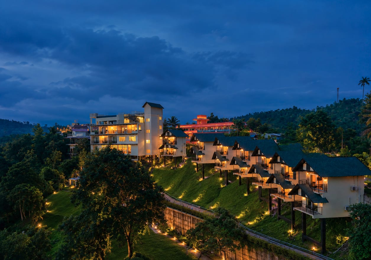 A hillside resort illuminated at dusk