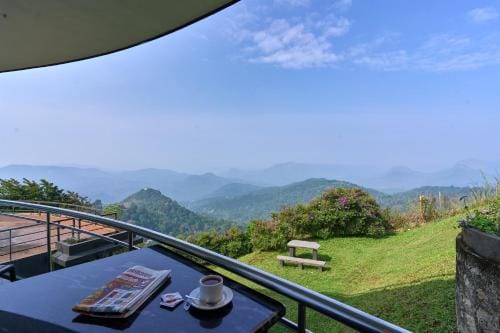 A terrace overlooking distant hills and a green garden