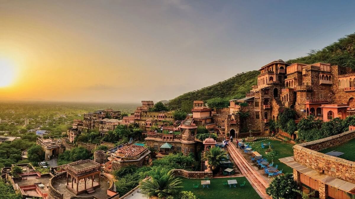 Terraced fort buildings on a hillside at sunset