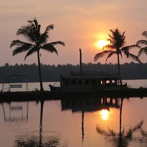 A houseboat silhouetted against the setting sun