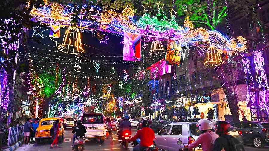 Colorful festive lights hanging above a busy street
