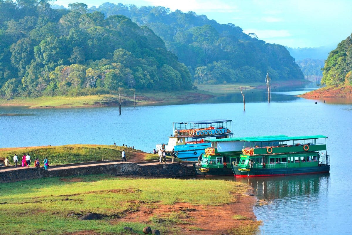 Passenger boats moored on a lake surrounded by hills