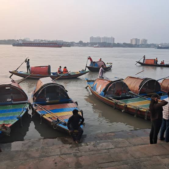 Small passenger boats gathered at a riverside landing