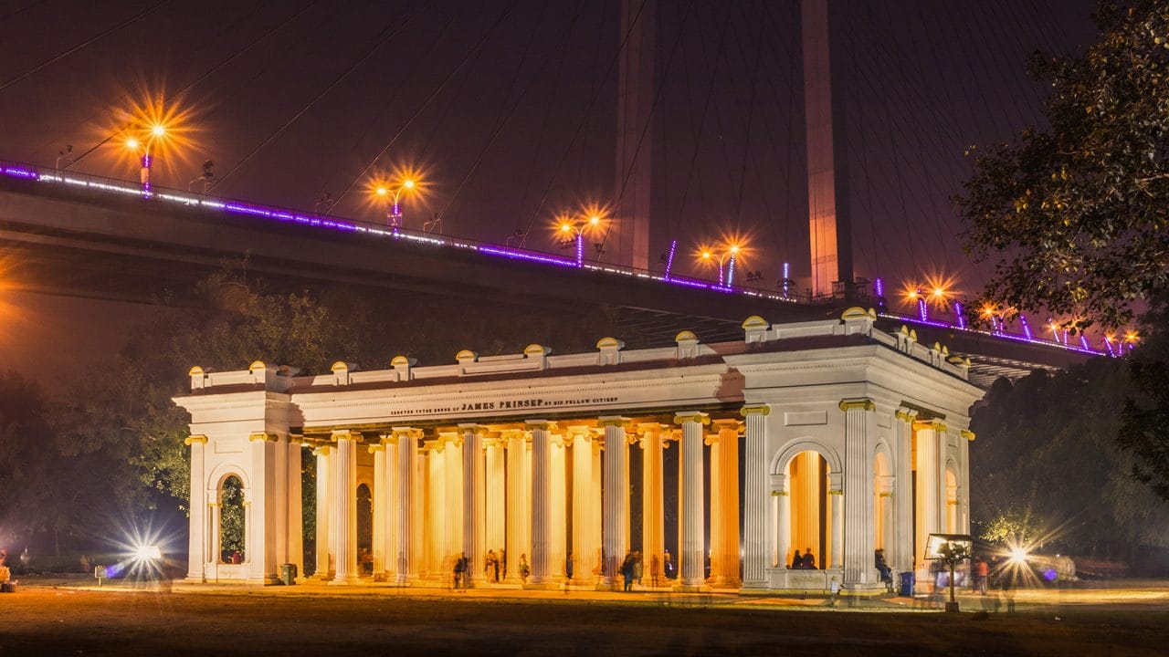 Prinsep Ghat illuminated beneath the bridge at night
