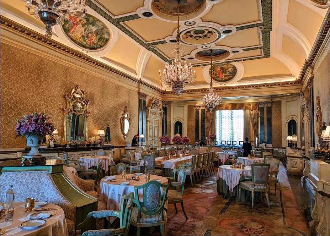 A formal dining room with ornate ceiling decoration