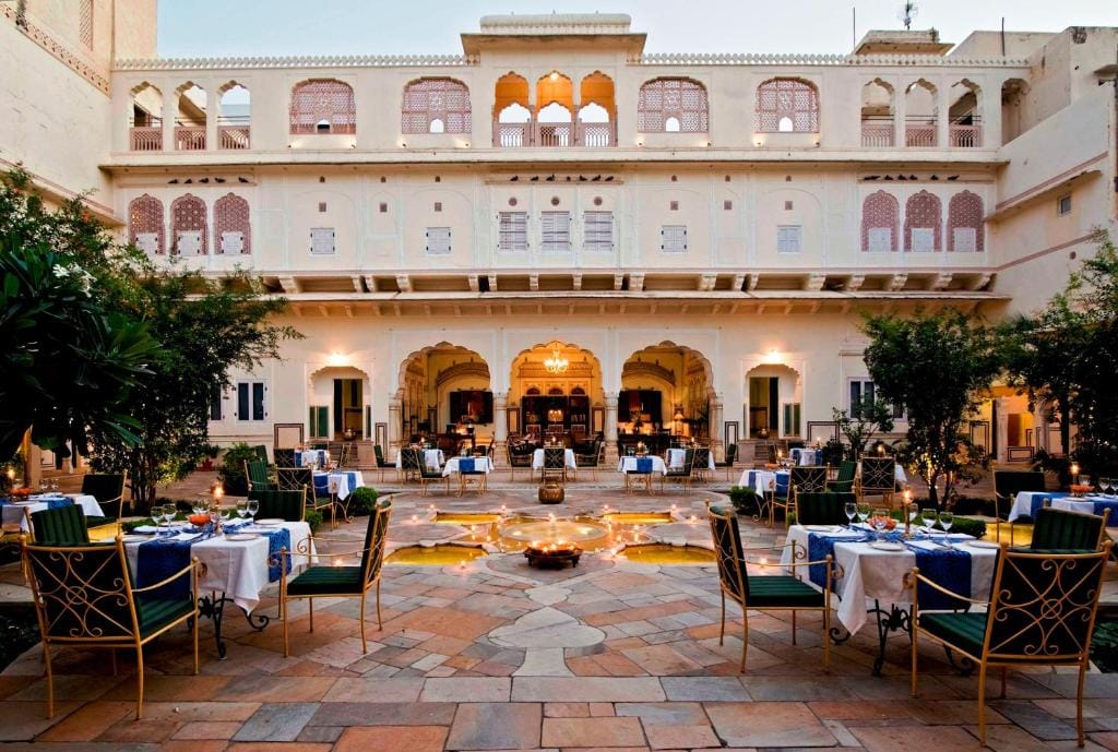 Outdoor tables in a heritage hotel courtyard