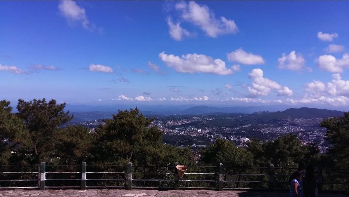 A hilltop viewpoint overlooking distant blue hills