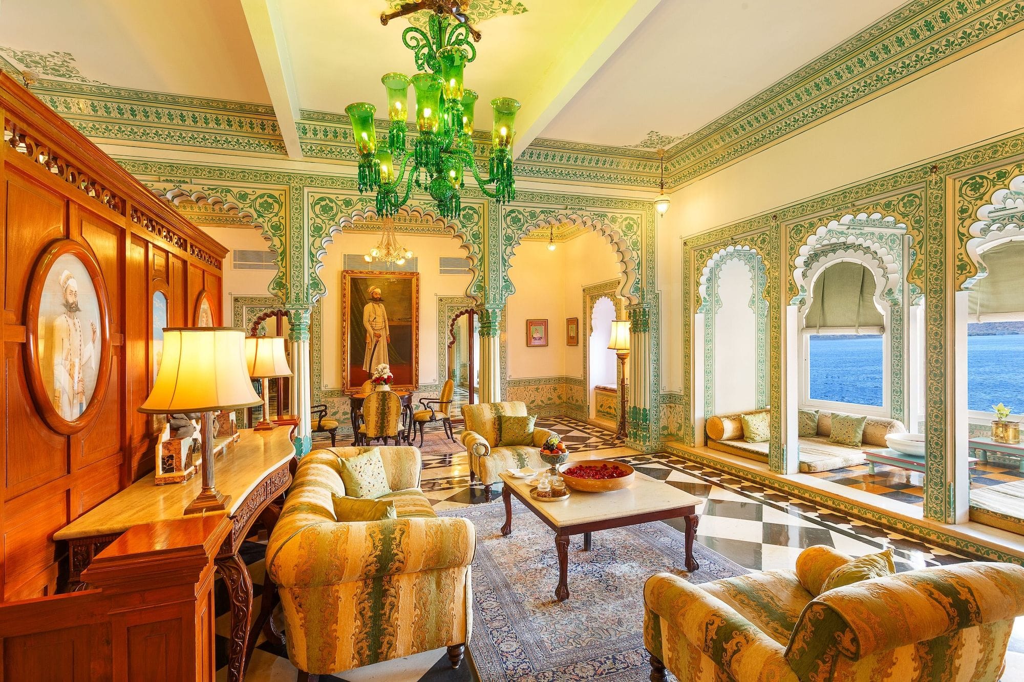 An ornate sitting room with gilded arches and floral decoration