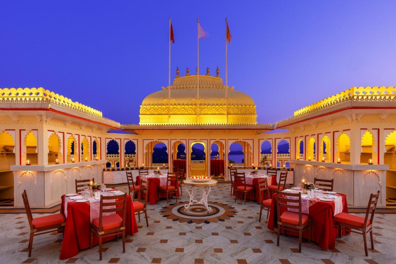 A rooftop dining terrace illuminated at dusk