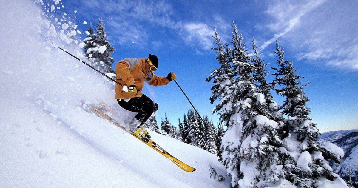 A skier jumping above a snowy slope