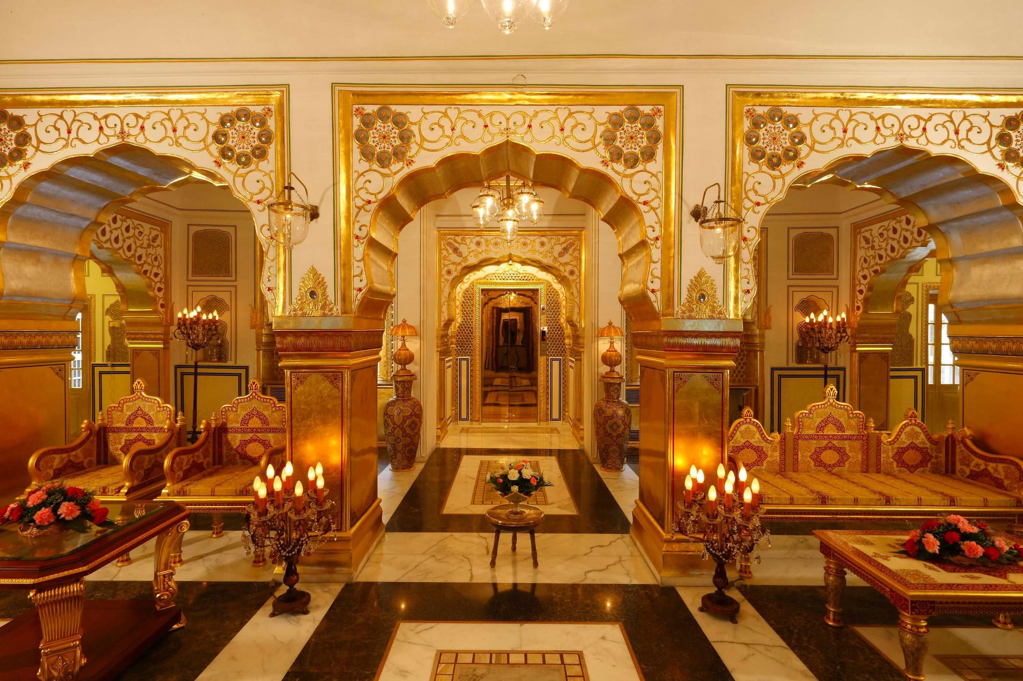 An ornate palace interior with gilded arches and candles