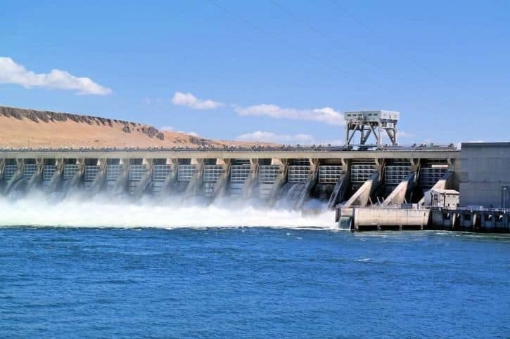 Water spilling across a dam into a lake