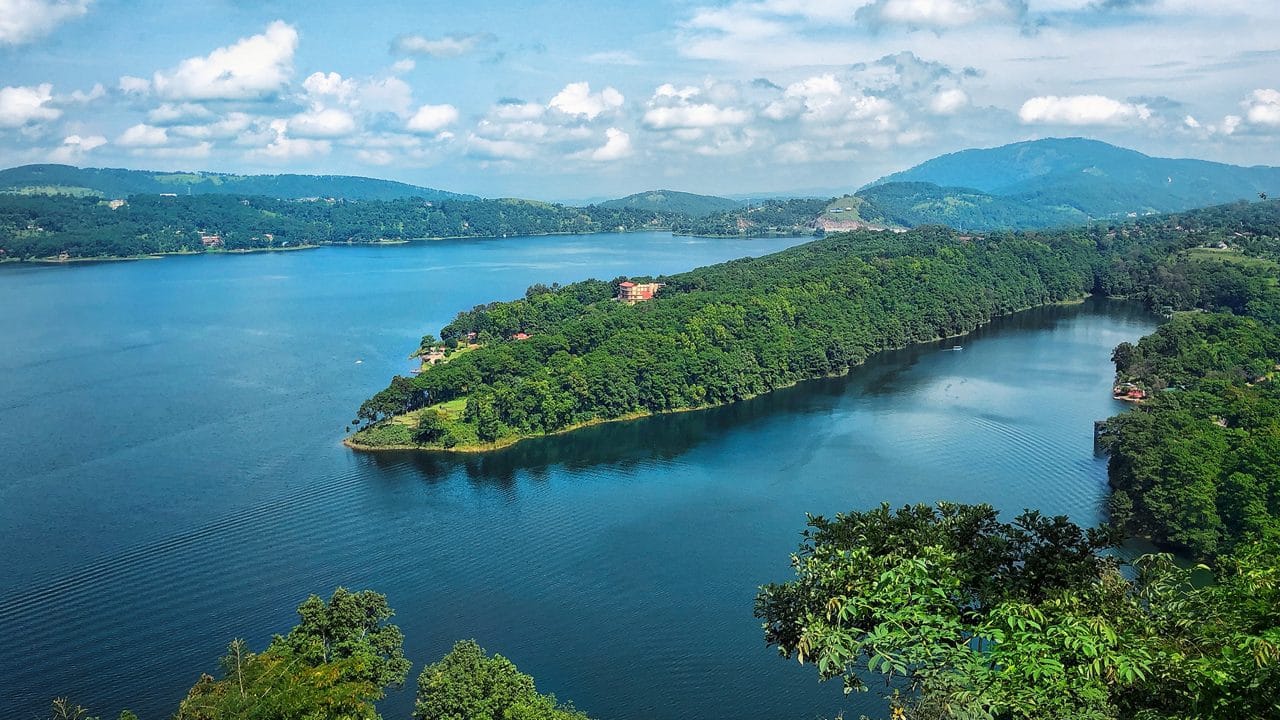 A wooded peninsula extending into a blue lake