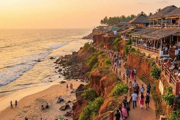 Visitors walking along a clifftop path overlooking the beach