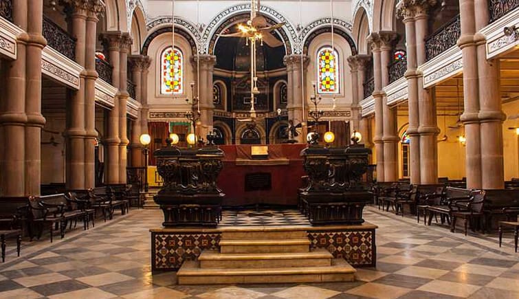 An ornate interior with arched galleries and carved columns