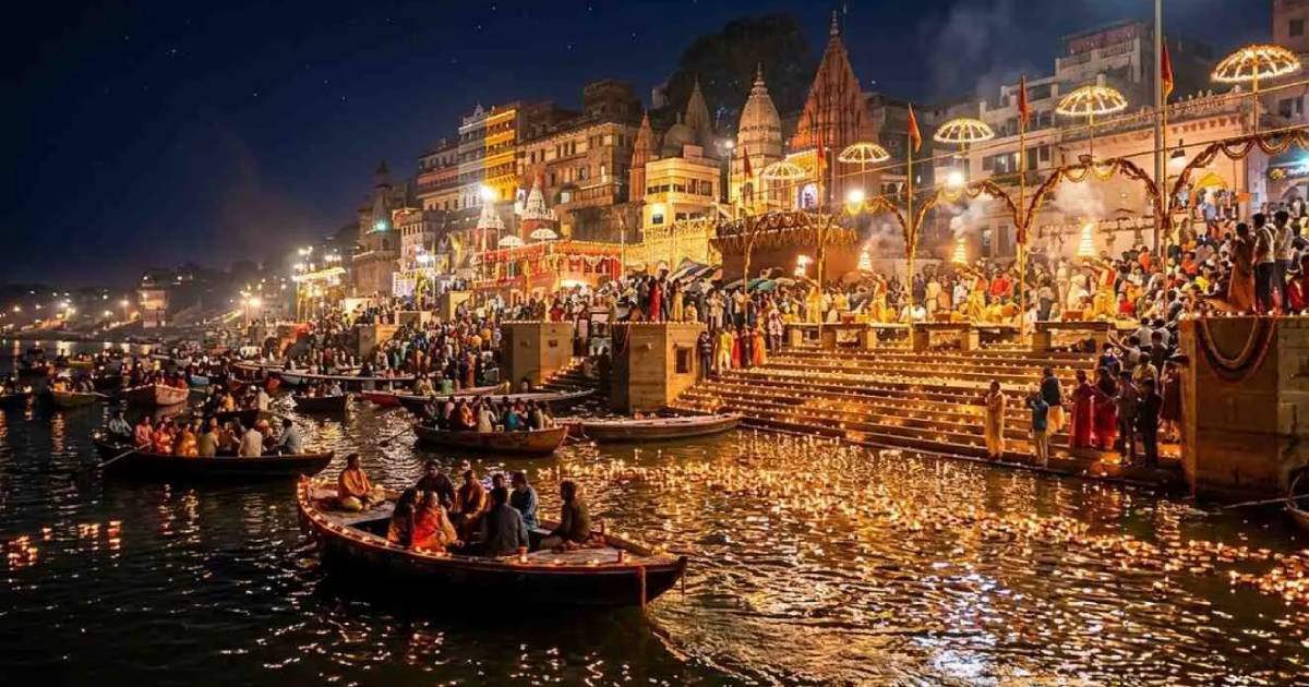 Illuminated riverside buildings and boats reflected in the water at night